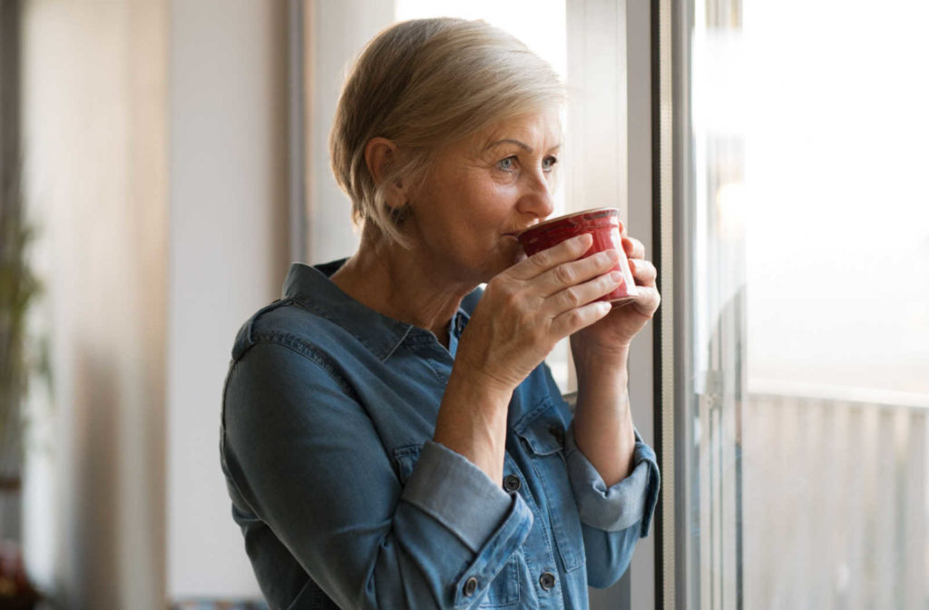 A senior woman enjoying a nice cup of coffee at the Bluffview Estates Senior Living Community in Winona, Minnesota.
