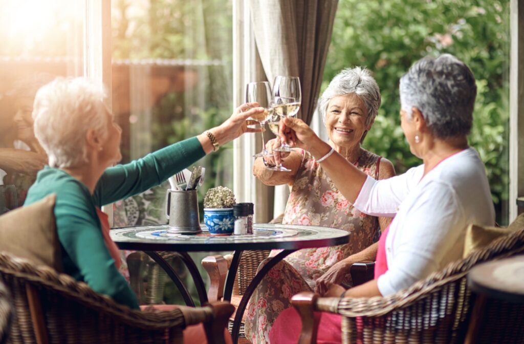 A group of seniors enjoying a glass of wine together at a senior living community