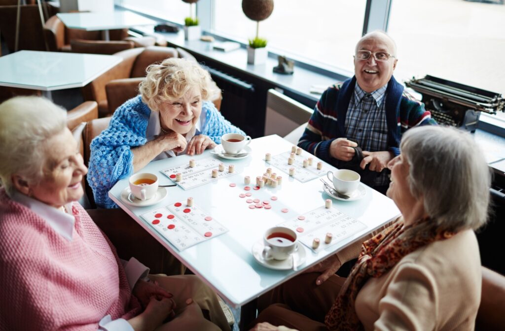 a group of seniors playing a board game while sharing smiles and laughter.